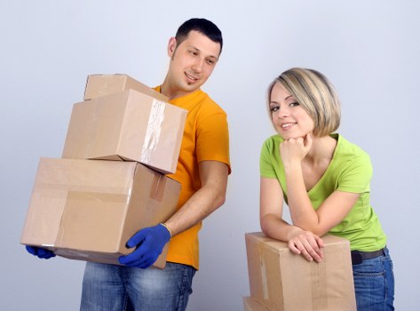 Packed moving boxes and wrapped furniture ready for flat removals
