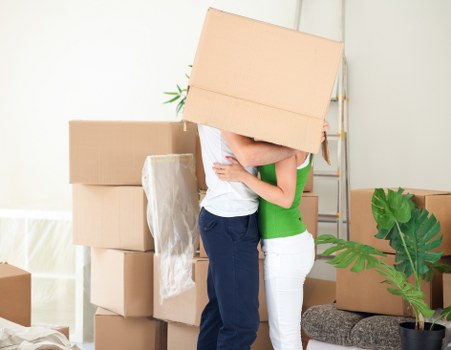 Mover carrying furniture down stairs during a Harringay flat removal