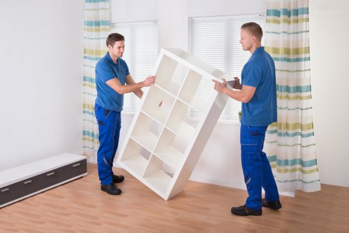 Removal team moving large furniture safely in Harringay