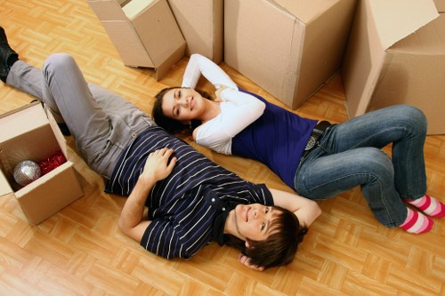Organised flat moving day with boxes, trolley, and removal van